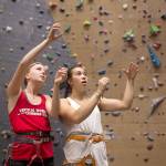 Climbers Laili Couper (left) and Sidney Trinidad plan a route Thursday while training at Vertical World in Seattle. (David Rzegocki / For the Herald)