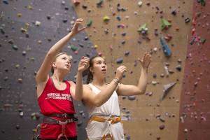 Climbers Sidney Trinidad and Laili Couper, in red, plan their route while practicing at Vertical World on Thursday, Aug. 10, 2017 in Seattle, Wa. (David Rzegocki / For The Herald)