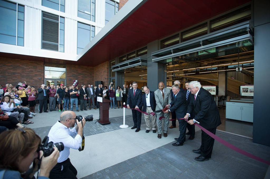 WSU dignitaries and guests cut the ribbon during an open house at the Washington State University Everett building on Tuesday. (Andy Bronson / The Herald)