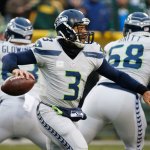 Seattle Seahawks&rsquo; Russell Wilson drops back during the first half of an NFL football game against the Green Bay last year. He is again featured in a series of commercial for Seattle-based Alaska Airlines. (File photo)
