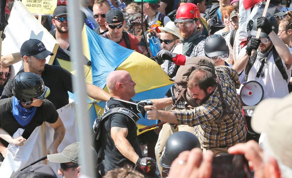 White nationalist demonstrators clash with counter demonstrators at the entrance to Lee Park in Charlottesville, Virginia, on Saturday. (AP Photo/Steve Helber)