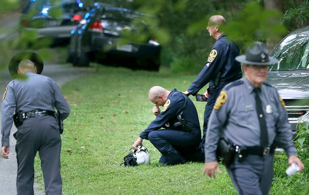 Authorities work near the scene of a deadly helicopter crash near Charlottesville, Virginia, on Saturday. (Shelby Lum/Richmond Times-Dispatch via AP)