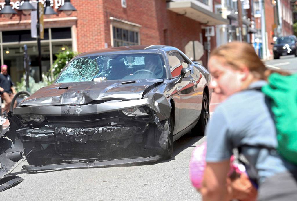 A vehicle reverses after driving into a group of protesters demonstrating against a white nationalist rally in Charlottesville, Virginia, on Saturday. (Ryan M. Kelly/The Daily Progress via AP)
