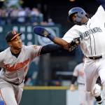 Baltimore Orioles second baseman Jonathan Schoop, center, reaches to tag out Seattle Mariners&rsquo; Guillermo Heredia after Heredia was caught in a run-down while trying to steal second base in the first inning of a baseball game Tuesday, Aug. 15, 2017, in Seattle. (AP Photo/Elaine Thompson)