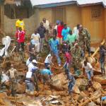 Volunteers search for bodies from the scene of heavy flooding and mudslides in Regent, just outside of Sierra Leone&rsquo;s capital Freetown on Tuesday. (AP Photo/ Manika Kamara)