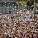 Pigeons fly over a crowd gathered for a minute of silence in memory of the terrorist attacks victims in Barcelona, Spain, on Friday. (AP Photo/Francisco Seco)