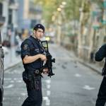Armed police officers patrol a deserted street in in Barcelona, Spain, on Friday. (AP Photo/Manu Fernandez)