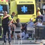 Injured people are treated in Barcelona, Spain, on Thursday after a white van jumped the sidewalk. (AP Photo/Oriol Duran)