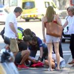 An injured person is treated in Barcelona, Spain, on Thursday after a white van jumped the sidewalk in the historic Las Ramblas district, crashing into a summer crowd of residents and tourists and injuring several people, police said. (AP Photo/Oriol Duran)