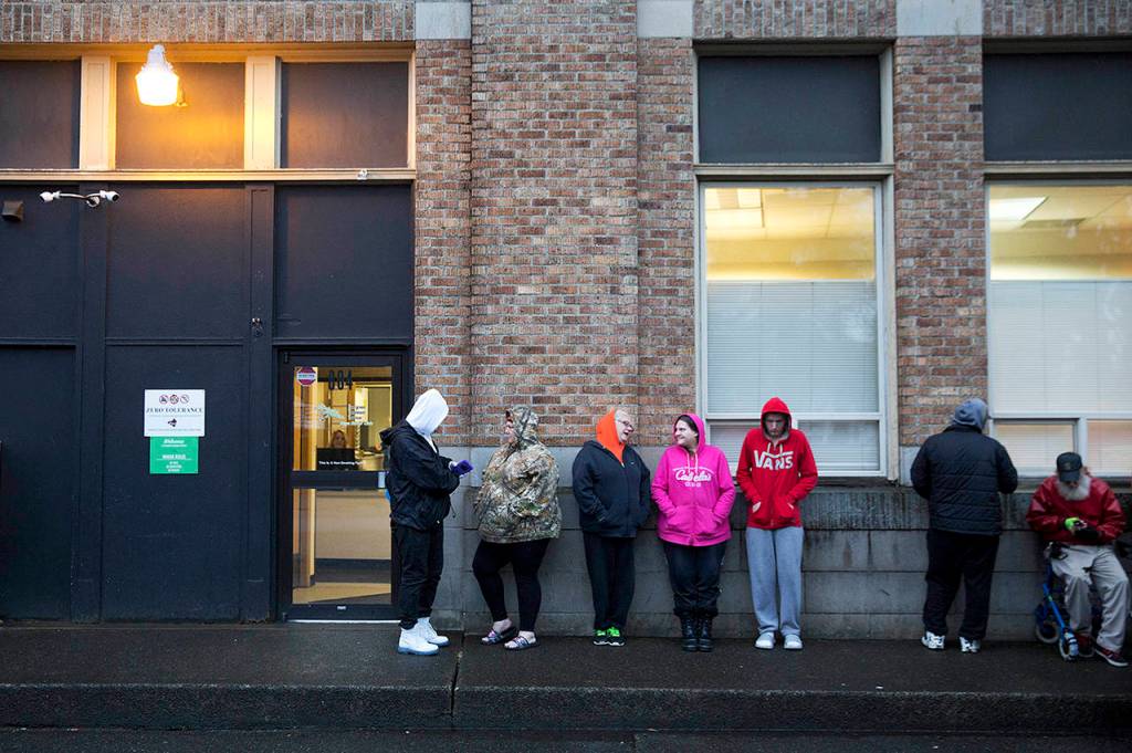 People wait in line for the Evergreen Treatment Services methadone clinic to open in Hoquiam on June 15. (AP Photo/David Goldman)