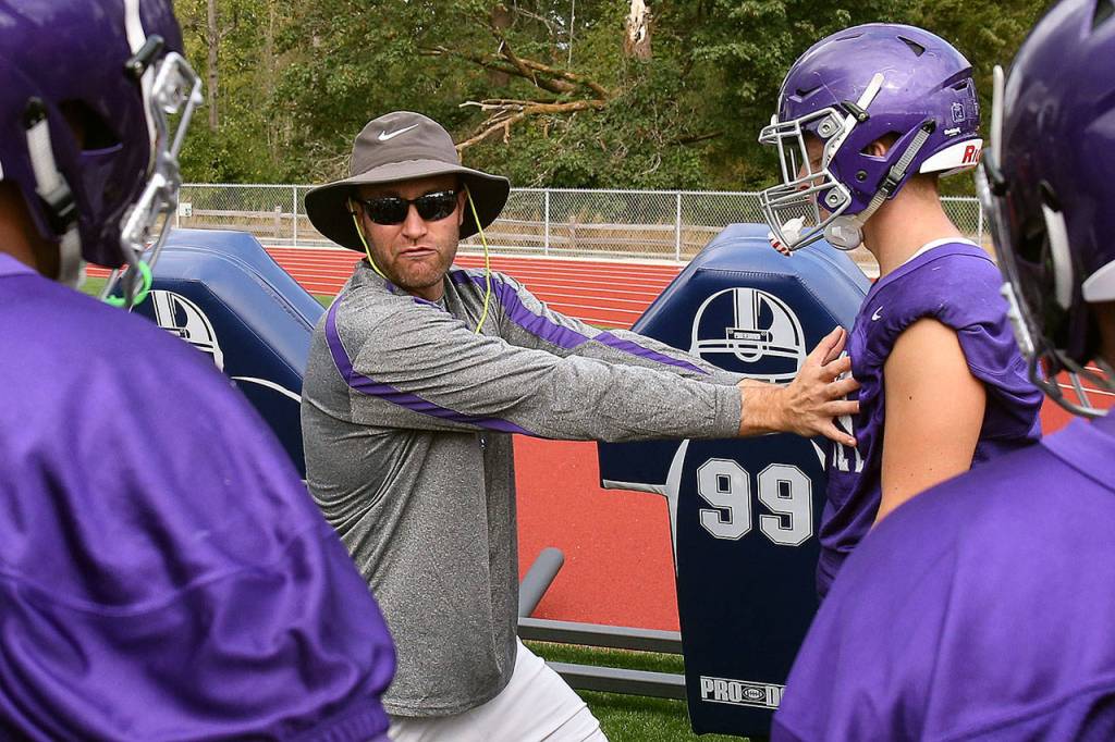 Kevin Clark / The Herald                                Torrey Myers, the head football coach at North Creek High School, instructs players during practice Friday at the school.
