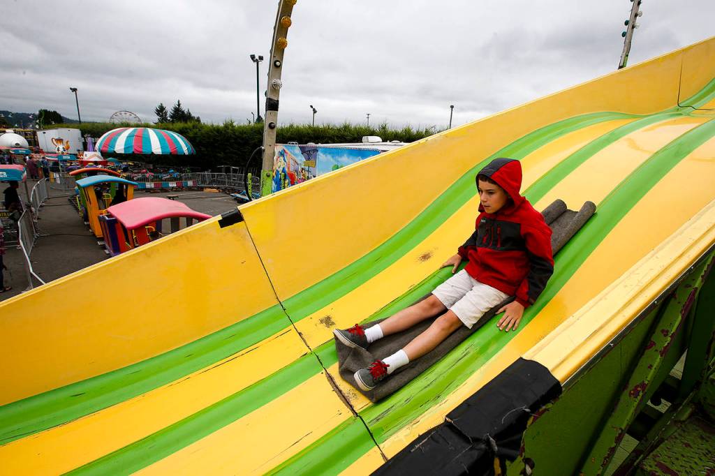 Nate McKiernan, 12, of Duvall, flies down a slide at the Evergreen State Fair in Monroe on Wednesday. (Ian Terry / The Herald)