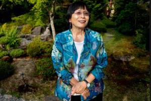 Mayumi Smith, director of Nippon Business Institute at EvCC since 1990, walks in the lovely Nishiyama Japanese Garden outside the institute this week, just a day away from retirement. (Dan Bates / The Herald)