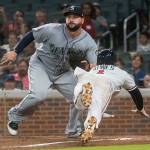 The Braves&rsquo; Ozzie Albies dives to home plate to score as Mariners first baseman Yonder Alonso waits for the throw after a rundown during the sixth inning of a game Aug. 22, 2017, in Atlanta. (AP Photo/John Amis)