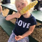 Paige devours corn on the cob, offered by the Nile Shriners of Mountlake Terrace, at the fair. (Family photo)