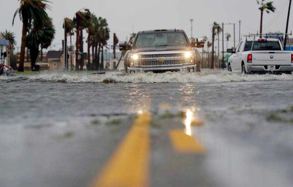 A car moves through flood waters left behind by Hurricane Harvey on Saturday in Aransas Pass, Texas. (AP Photo/Eric Gay)