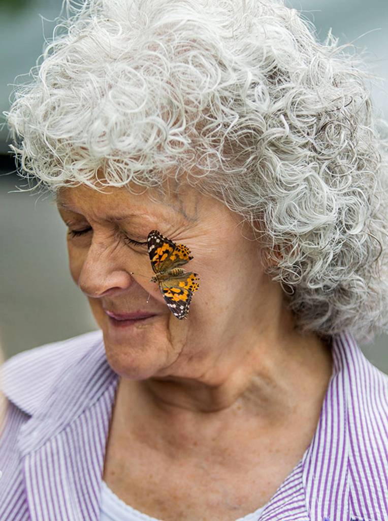 Judy White reacts as a butterfly lands on her cheek during the opening day of the 2017 Evergreen State Fair on Aug. 24 in Monroe. (Andy Bronson / The Herald)