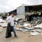 Miguel Debernardis cleans up debris in the aftermath of Hurricane Harvey on Saturday in Katy, Texas. (AP Photo/David J. Phillip)