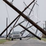 A driver works his way through a maze of fallen utility poles damaged in the wake of Hurricane Harvey on Saturday in Taft, Texas. (AP Photo/Eric Gay)