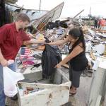 Kenneth Byrant and his wife, Jennifer Byrant, search through debris from Bryant&rsquo;s Auto Sales in Katy, Texas, after a possible tornado during Hurricane Harvey on Saturday. They were looking for cars keys and paperwork. (Melissa Phillip /Houston Chronicle via AP)