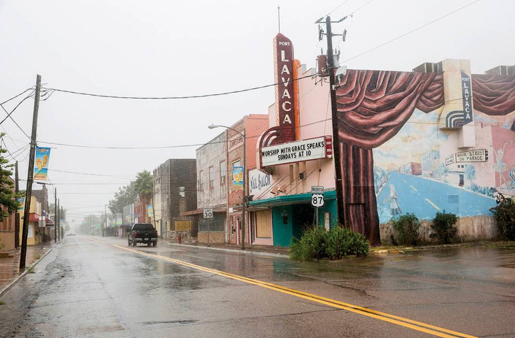 A single truck drives down a street as Hurricane Harvey makes landfall in downtown Port Lavaca, Texas on Friday. (Ana Ramirez/The Victoria Advocate via AP)
