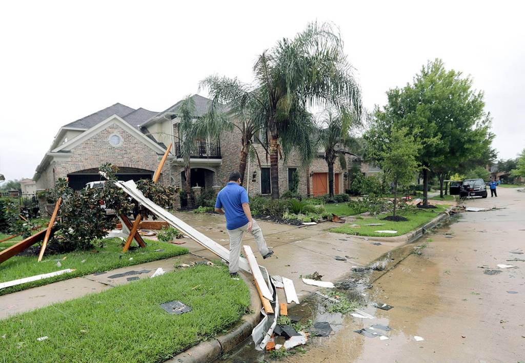 A contractor walks over debris from Hurricane Harvey on Saturday in Missouri City, Texas. (AP Photo/David J. Phillip)