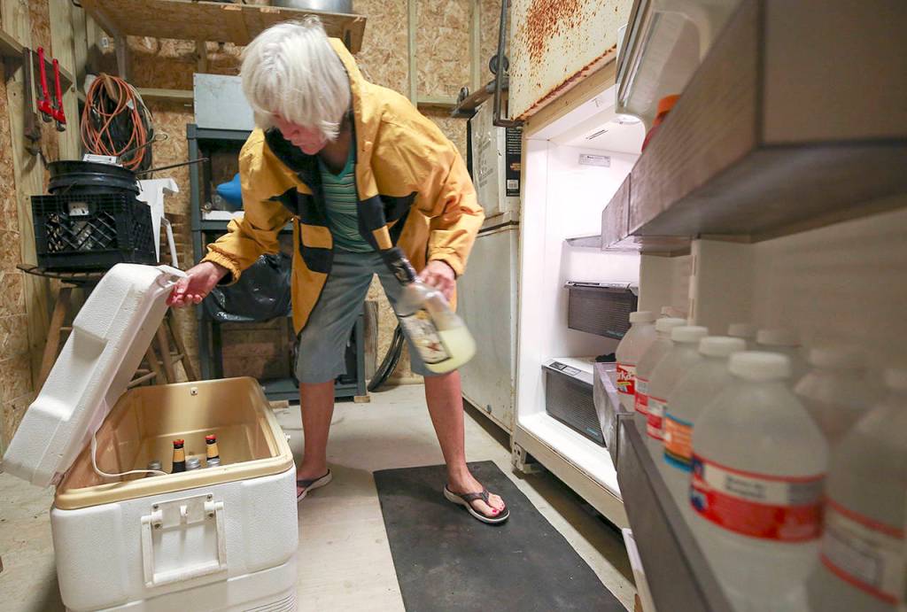Carolyn Price empties a fridge on the lower level of her property in Matagorda, Texas before Hurricane Harvey makes landfall Friday. (Godofredo A. Vasquez/Houston Chronicle via AP)