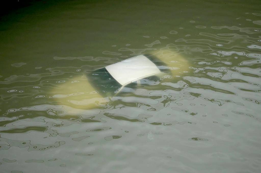 A car is submerged on a freeway flooded by Tropical Storm Harvey on Sunday near downtown Houston, Texas. (AP Photo/Charlie Riedel)
