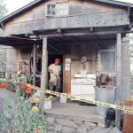 In this Aug. 31, 1992 photo, federal agents gather evidence from the home of captured fugitive Randy Weaver near Naples, Idaho. (AP Photo/Gary Stewart, File)