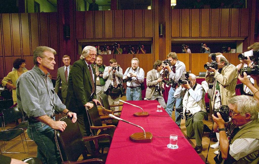In this Sept. 6, 1995 photo, photographers capture the arrival on Capitol Hill in Washington of Randy Weaver (left) and his attorney Gerry Spence for a hearing of a Senate Judiciary subcommittee. (AP Photo/Dennis Cook, File)