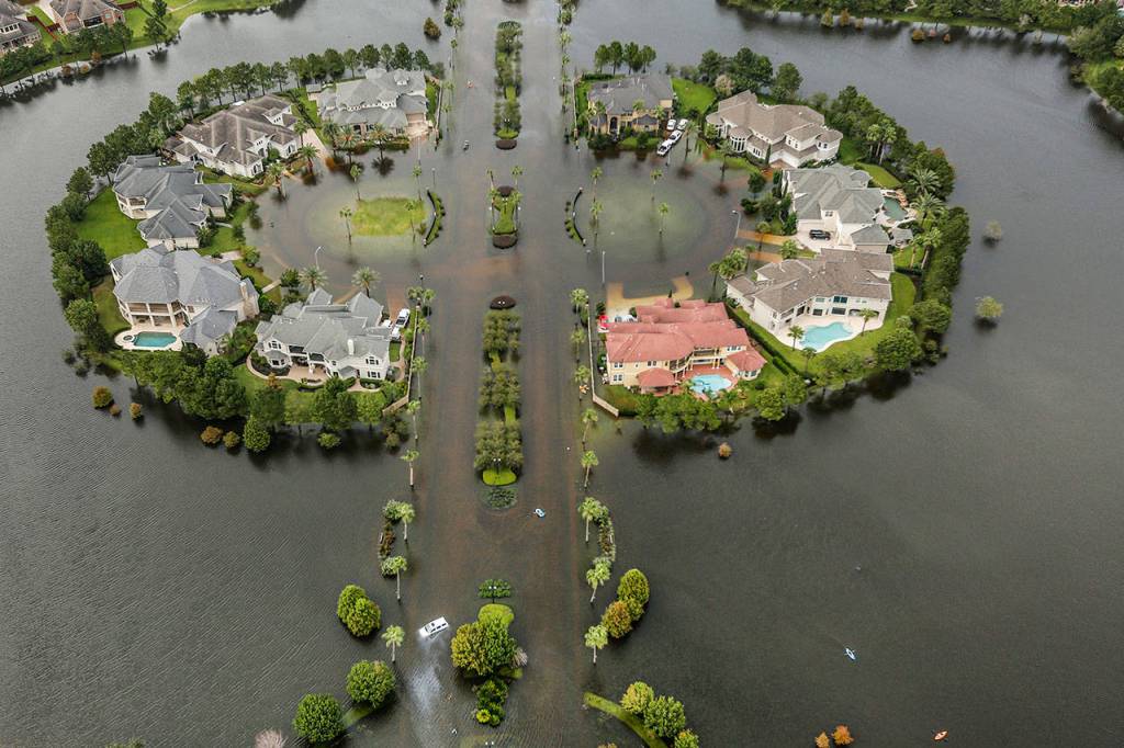 Floodwaters fill the road running through the Lakes On Eldridge North subdivision in the aftermath of Tropical Storm Harvey on Wednesday in Houston. (Brett Coomer/Houston Chronicle via AP)