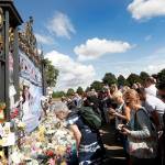 People crowd around the gates of Kensington Palace in London to pay tribute to the late Diana, Princess of Wales, on Thursday. (AP Photo/Kirsty Wigglesworth)