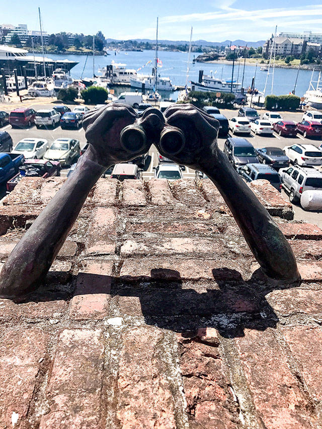 Victoria Harbour is replete with works of art, such as this sculpture of hands with binoculars. (Andrea Brown / The Herald)