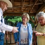 Ellen Snow, right, counts off the number of last names she&rsquo;s had while chatting with Glenn &ldquo;Clyde&rdquo; Fields and Crystal Johanson as a dozen graduates plus their spouses attend Snohomish High School Class of 1942&rsquo;s 75th reunion at Hill Park on Sept. 6 in Snohomish. (Andy Bronson / The Herald)