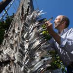 Jerry Gay has been putting feathers, found in his yard, into a unused power pole on Madison Street for the past two years. (Andy Bronson / The Herald)