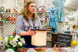 Following about 25 years as an Evergreen State Fair judge and contestant, Laura Elhai is the 2017 Fair Honoree. This year, she heads the American Heritage exhibit on the 1950s and judged baking and canning. Here, Elhai sets a crock pot of fermented sauerkraut on the table in a 1950s era kitchen display. (Dan Bates / The Herald)