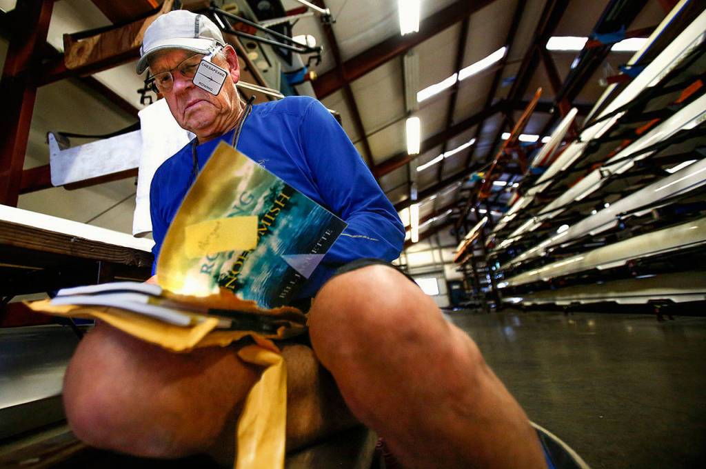 In the Everett Rowing Association shell house, Jaquette signs three books for some young rowers who found out about his book, &ldquo;Rowing on the Snohomish.&rdquo; (Dan Bates / The Herald)