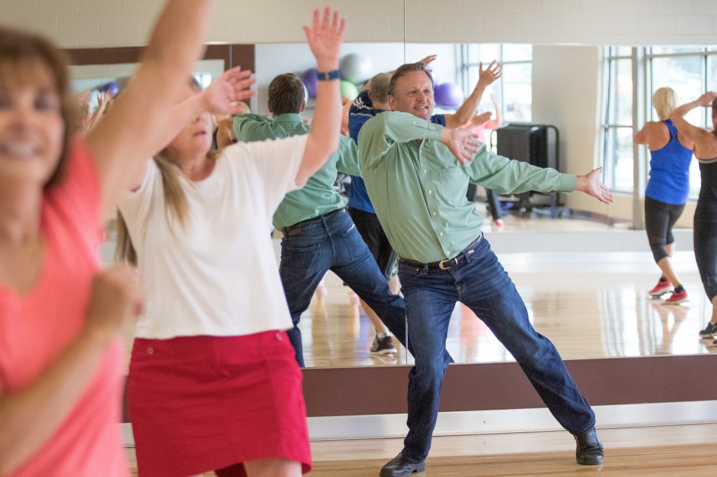 Greg Abbey, board president of the Mukilteo YMCA, dances during a zumba class at the September 2016 grand opening of the Stanwood-Camano YMCA. (Andy Bronson / Herald file)