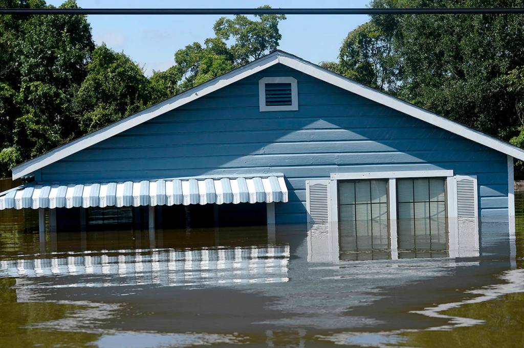 A house is flooded due to Hurricane Harvey in the north end of Beaumont, Texas, on Thursday. (Ryan Pelham/The Beaumont Enterprise via AP)