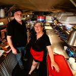 Henry and Leanne Smiciklas run their barbecue food truck out of an old school bus on U.S. 2, a few miles east of Monroe. (Dan Bates / The Herald)