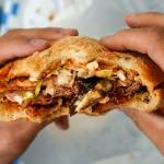 Customer Adam Chapman devours a barbecue sandwich at the Old School BBQ. Dan Bates / The Herald