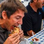 Customers Adam Chapman (left) and Ed Harrison chow down at the Old School Bus BBQ. Dan Bates / The Herald
