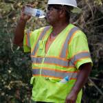 A construction worker drinks water while on a break from working on a street paving crew Friday, Sept. 1, 2017, in Orinda, Calif. Dozens of cooling centers opened throughout California, schools let students out early and outdoor events were cancelled as temperatures soared from a heat wave expected to last through the Labor Day weekend. (AP Photo/Ben Margot)