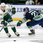 The Silvertips&rsquo; Pavel Azhgirei controls the puck with the Thunderbirds&rsquo; Luke Ormsby reaching in during the first period of a preseason game on Sept. 2, 2017, at Xfinity Arena in Everett. (Kevin Clark / The Herald)
