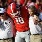 Georgia quarterback Jacob Eason (10), a Lake Stevens alum, is helped off the field after an injury during the first quarter of a game against Appalachian State on Sept. 2, 2017, in Athens, Ga. (AP Photo/John Amis)
