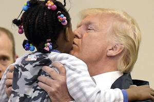 Upbeat Trump pitches in at shelter for Harvey victims