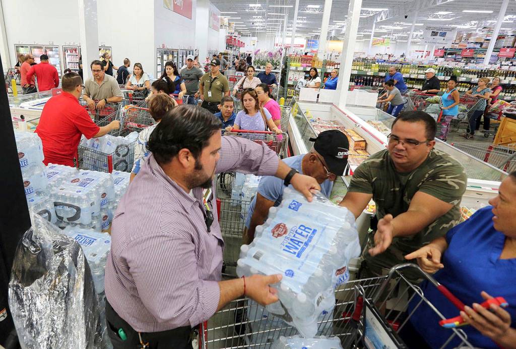 Residents purchase water at BJ Wholesale in preparation for Hurricane Irma on Tuesday in Miami. (Roberto Koltun/Miami Herald via AP)