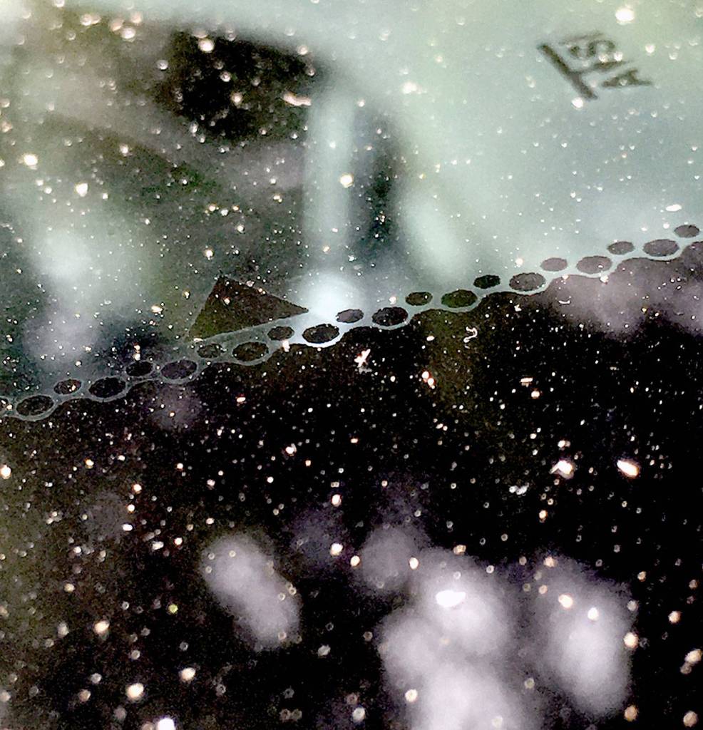 Ash falls onto a car in an Everett parking lot Tuesday morning. (Sue Misao / The Herald)