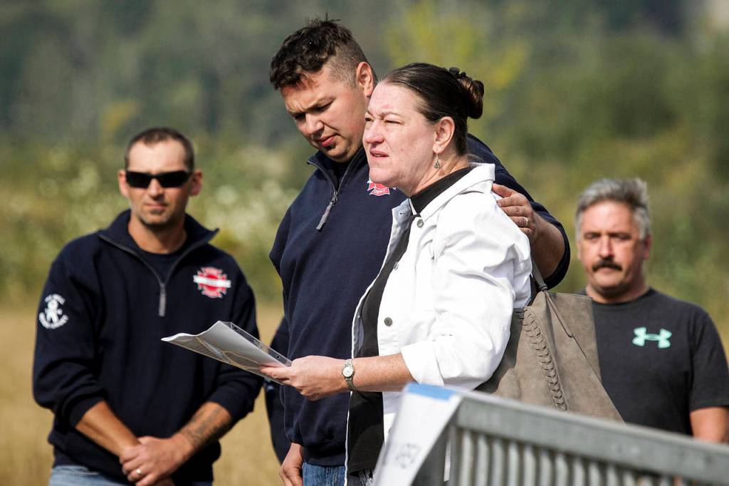 The Rev. Janet Loyd speaks during a ceremony held before the removal of a Sitka spruce at the Oso mudslide site on Saturday, Sept. 16. (Ian Terry / The Herald)