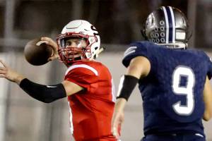 Snohomish&rsquo;s Langdon Orgill drops back to pass with Glacier Peak&rsquo;s Juhno Lindsay closing Friday night at Veterans Memorial Stadium in Snohomish. (Kevin Clark / The Herald)
